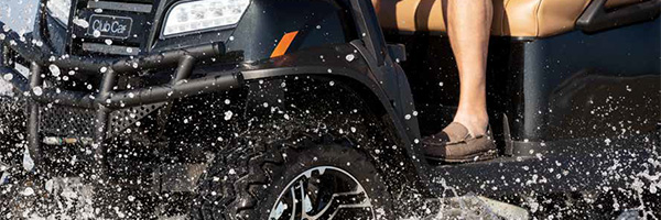 golf cart driving through water